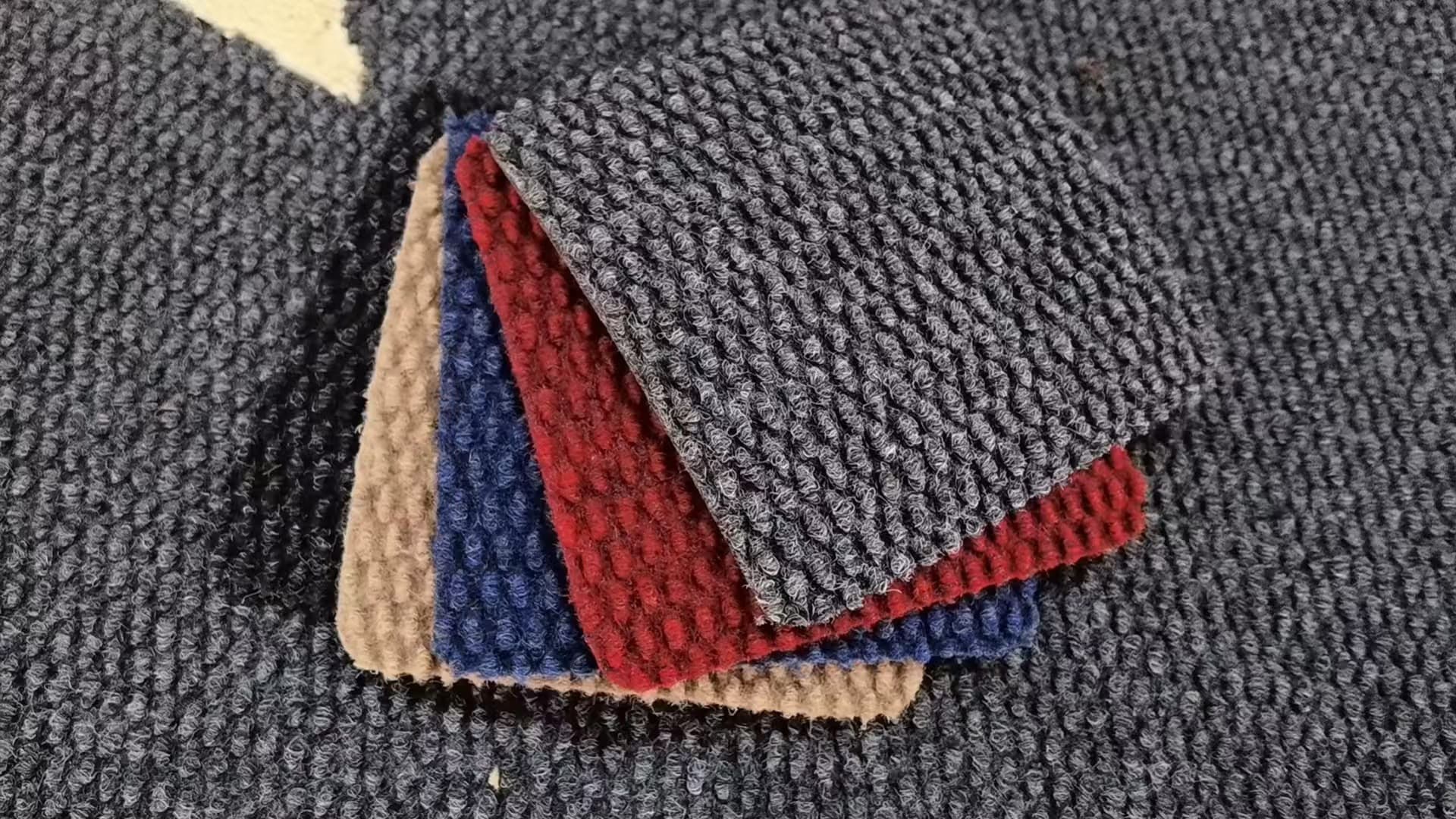 Ribbed nylon carpet swatches in charcoal, red, blue and beige